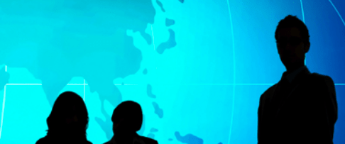 Decorative image. Group of people, in silhouette, looking at a map of the world.